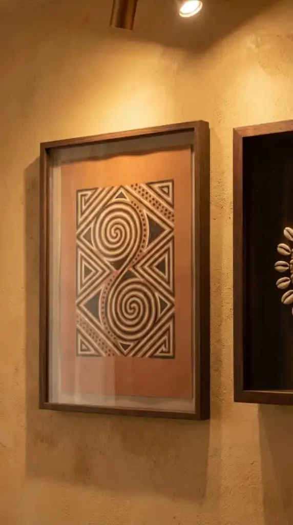 Abstract-scarification-geometry-print-beside-cowrie-shell-shadow-box