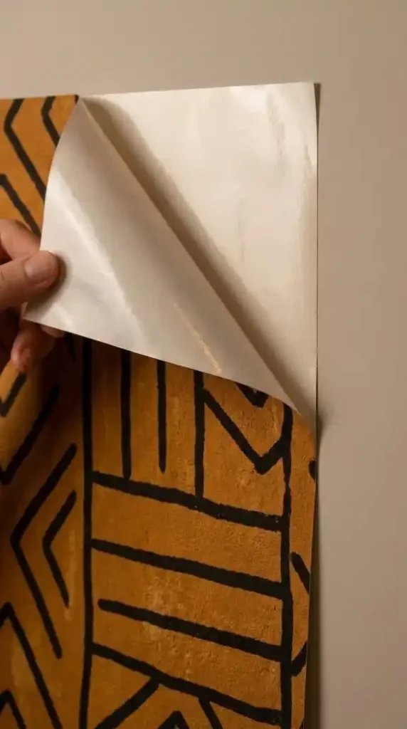 adhesive-backing-peeled-removable-layer-mud-cloth-pattern-ochre-black-matte-chalky-finish