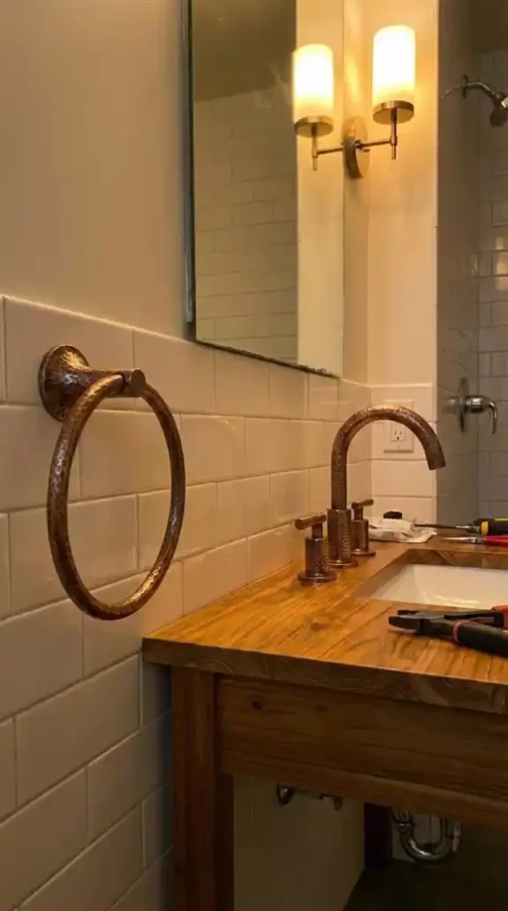 close-up of hammered copper bathroom hardware being installed