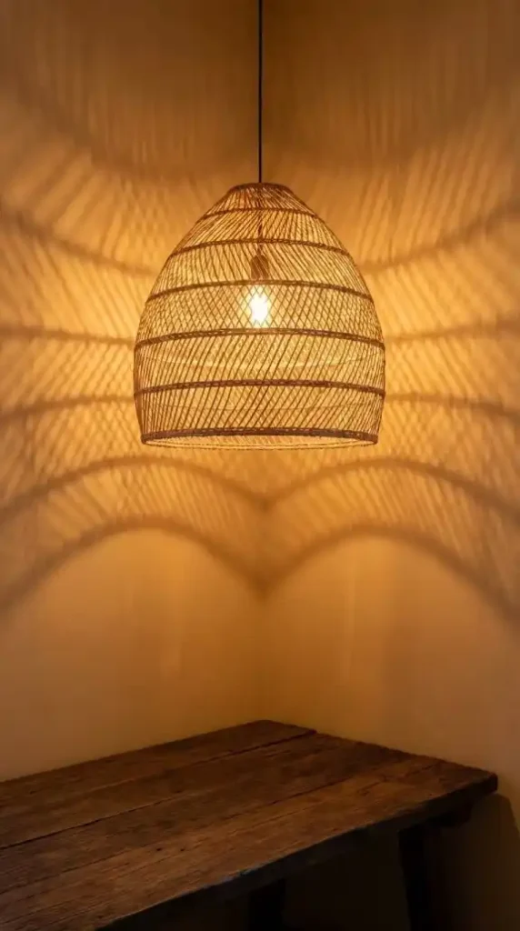 Large-raffia-pendant-casting-geometric-shadow-projections-above-walnut-desk