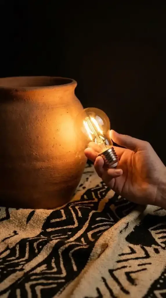 the-warm-amber-light-from-the-bulb-illuminating-both-objects-in-their-correct-earth-pigment-tones