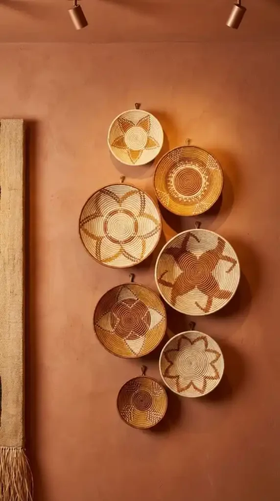 Seven-Tonga-baskets-arranged-asymmetrically-on-warm-terracotta-plaster